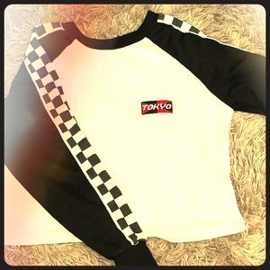 White crop top with checkered sleeves.